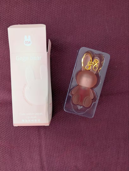 Bunny lip gloss in packaging tray next to pink box shade 03