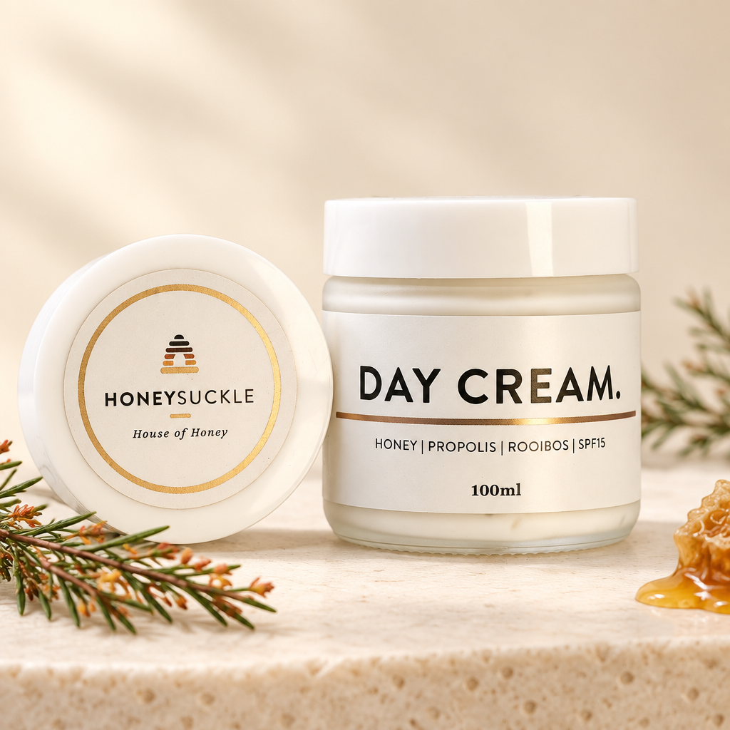Honeysuckle Day Cream 100ml glass jar with honey, rooibos and a white lid in a warm ivory setting