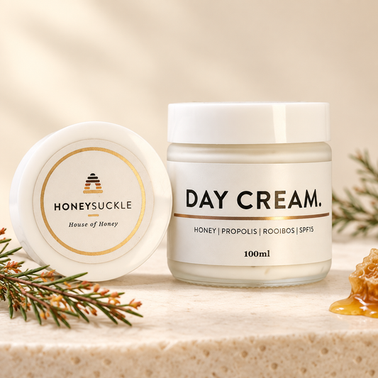 Honeysuckle Day Cream 100ml glass jar with honey, rooibos and a white lid in a warm ivory setting
