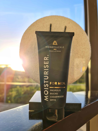Honeysuckle Moisturiser For Men SPF15 100ml by a window at sunset