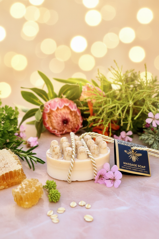 Honeysuckle Massage Soap hero shot with protea flowers and botanicals