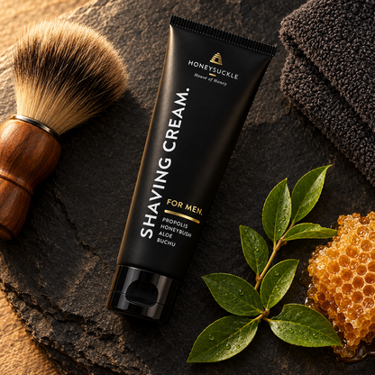 Honeysuckle Shaving Cream For Men 125ml on dark slate with shaving brush, leaves and honeycomb